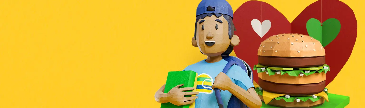 Um cartoon boy de chapéu e camisa azuis segurando um objeto verde e amarelo fica ao lado de um grande hambúrguer, com fundo de coração amarelo e vermelho, celebrando o McDia Feliz Instituto Ayrton Senna.